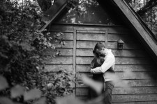 A couple posing in front of Kip's dog house at Lichgate on High Road